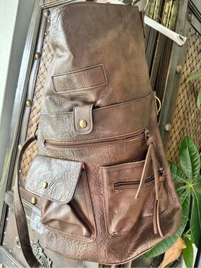 convertible crossbody bag designed to  transform into a backpack vegan leather